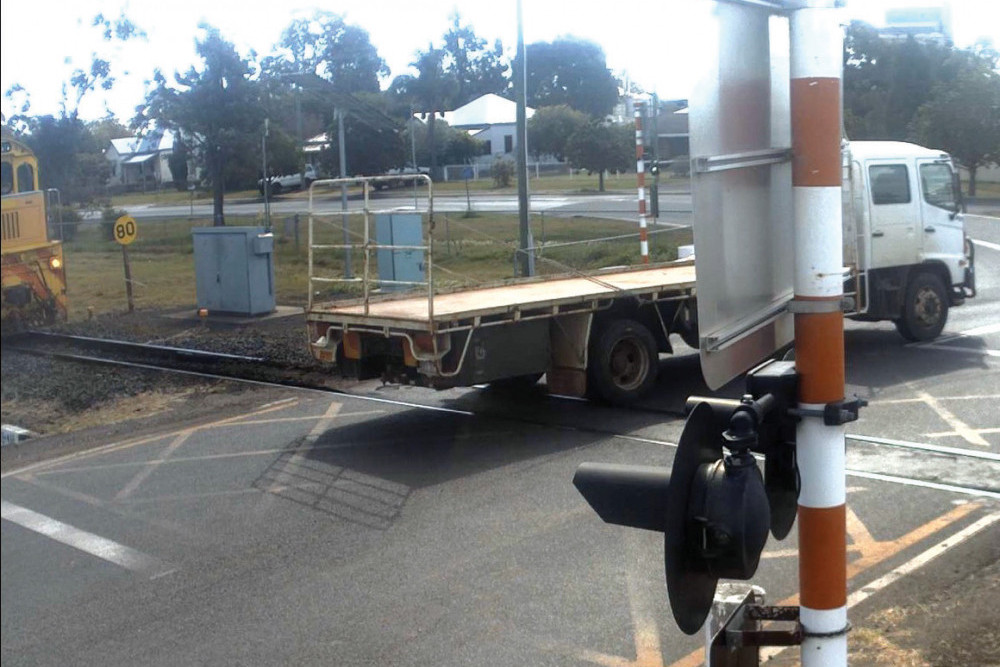 The Queensland Rail cameras caught this vehicle crossing in front of a train recently. See the yellow Aurizon train at the left of the photo for an indication of how close the truck came to being struck.