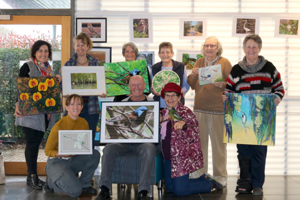 The artists of the 3Ps with their artwork; standing: Krissy Bange, Jenny Marshall, Kerry Chant, Sally Argent, Merlene Konz, Vee Cashin; seated: Angela Hart, Jim Argent, Rhonda Jenner.