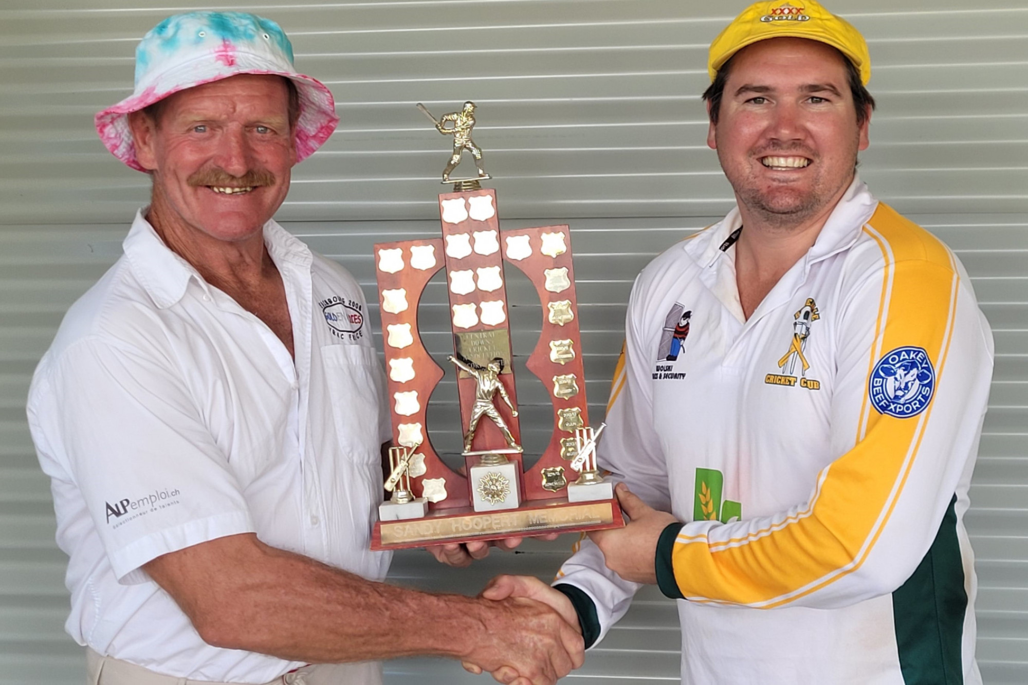 Owen Hoopert presents Bowenville Cricket Club Captain, Danny Johnstone, with the Sandy Hoopert Memorial Trophy for winning the First Round.