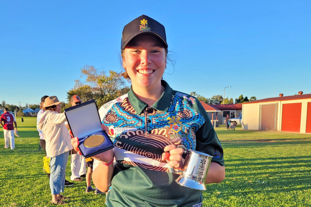 Local cricketer Jorja Charles with her medal.