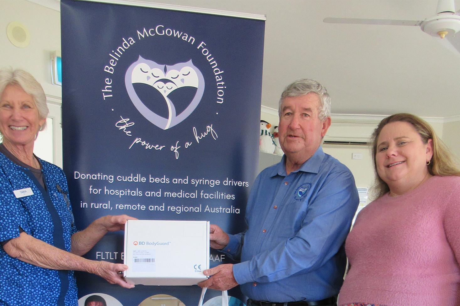 Presentation by Rod Kelly a Director of Belinda McGowan Foundation to Homestead Clinic EN Tania Wilson (left) with Acciona representative Katie Unipan.