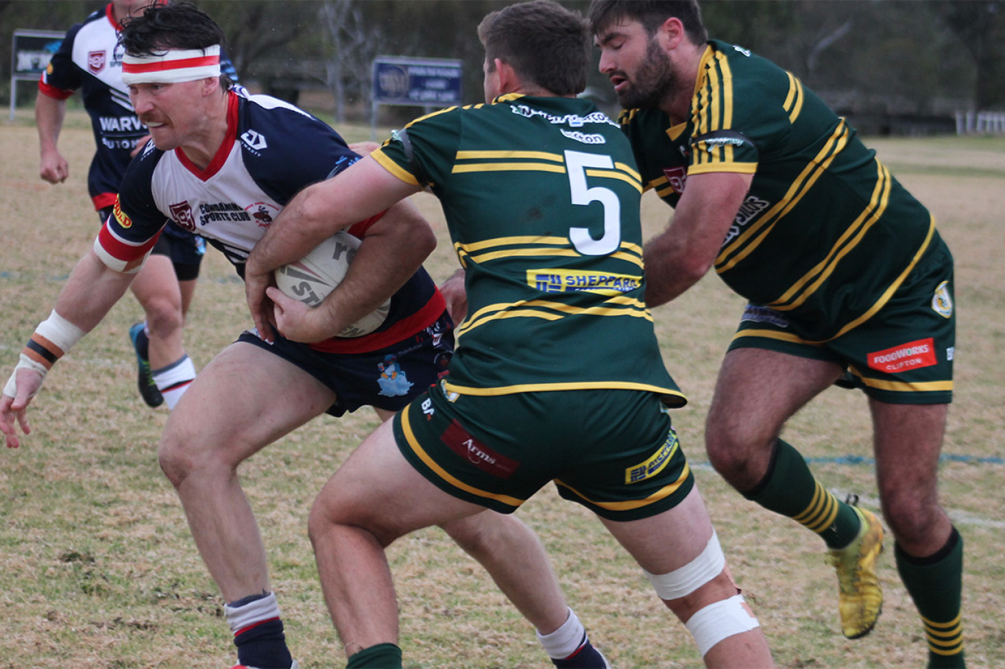 Warwick lock Mitch Wilson tries to evade Wattles backs Mitch Bourke at Matthew Christensen in Sunday’s first grade clash. (Image – Gerard Walsh)