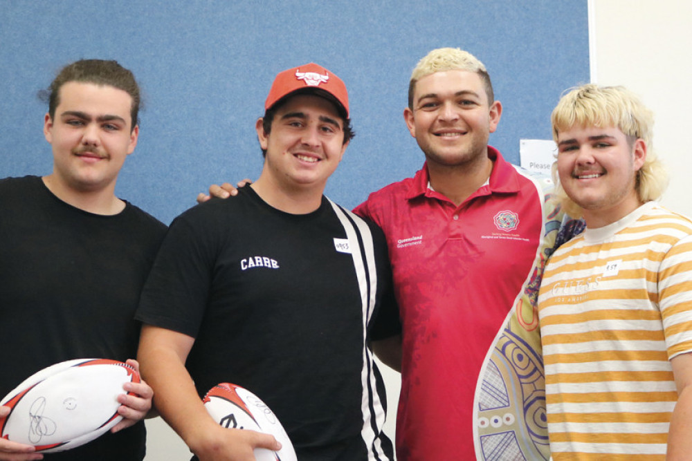 NRL player Ash Taylor (centre right) chats with local students Harry Sharpe-Liston, Kaleb Stanton and Hamish Sharpe-Liston who attended the vaccine clinic at Oakey State High School at the weekend.