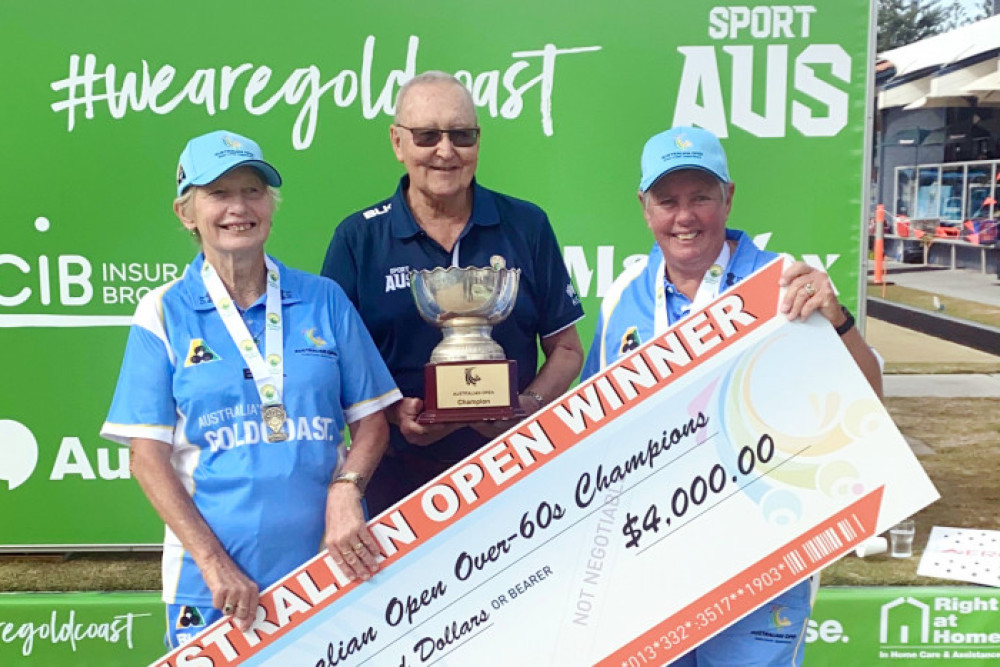 Maree Gibbs (left) from Millmerran Bowls Club and Sue Brady (right) from Mareeba Bowls Club are presented their trophy and cheque by CEO of Bowls Australia Neil Dalrymple (centre) after winning the Over 60s Ladies Pairs section of the Australian Open Bowls Championships.