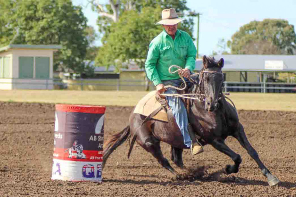 Peter Crichton competes in a barrel race.