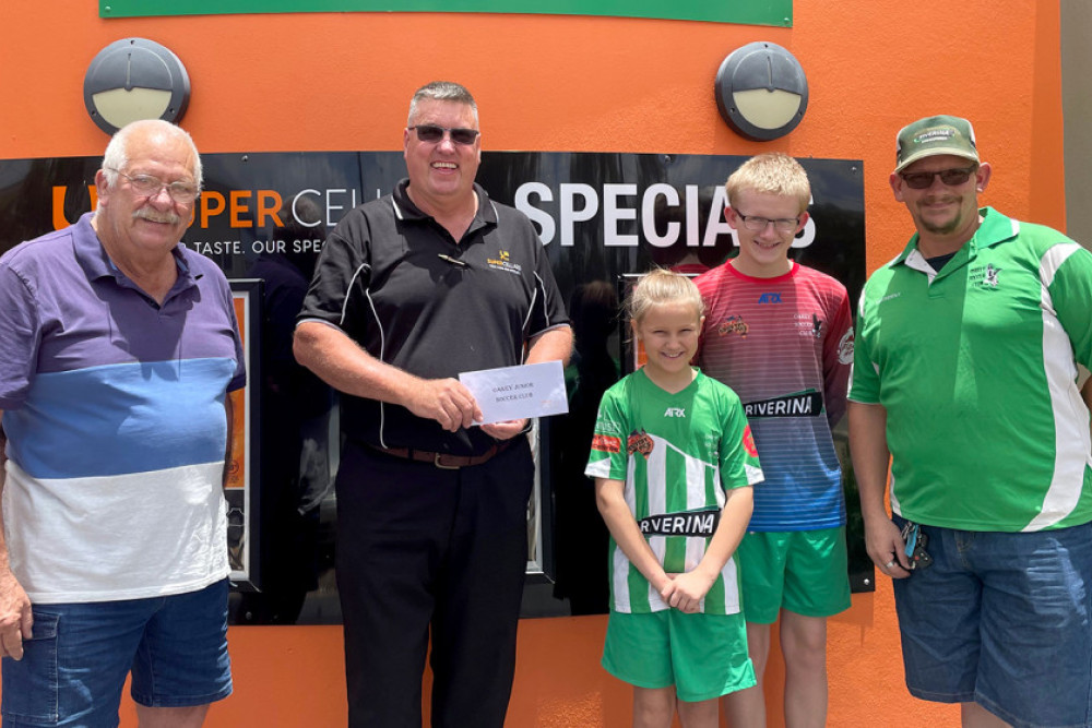 Community Chest raffle coordinator John Webster and Michael Carpenter owner of the Bernborough Tavern with Ray, Sean and Chelsea Cooper from the Oakey Soccer Club.