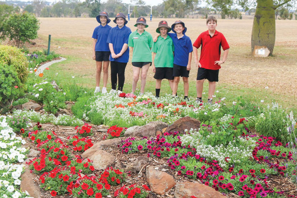 Students in front of the gardens at the main gate on Toowoomba-Cecil Plains Road, which can be easily viewed by members of the public.