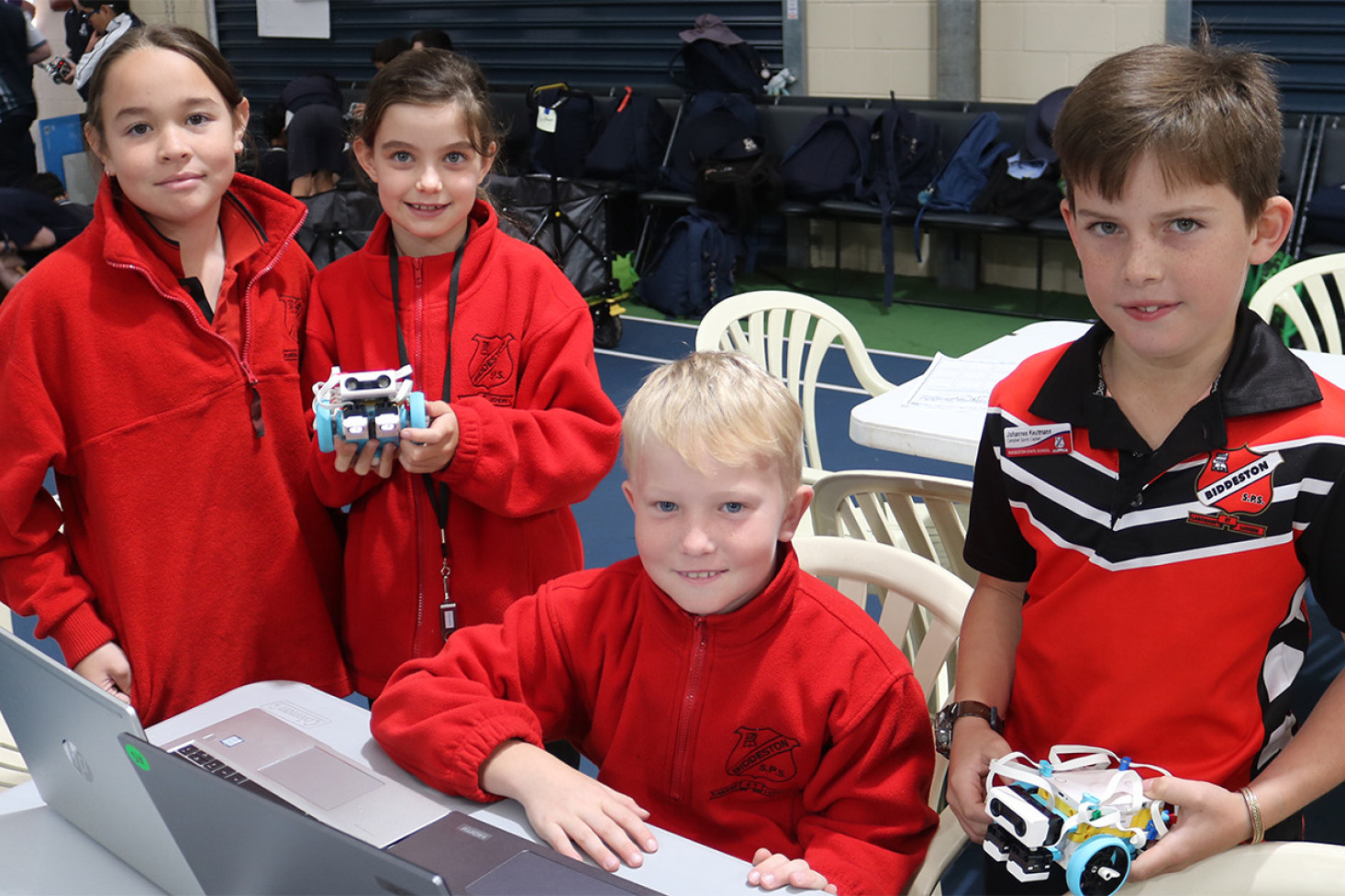 Biddeston State School students Lilly, Izzy, Emmerson and Johannes brainstorming together with their robots.