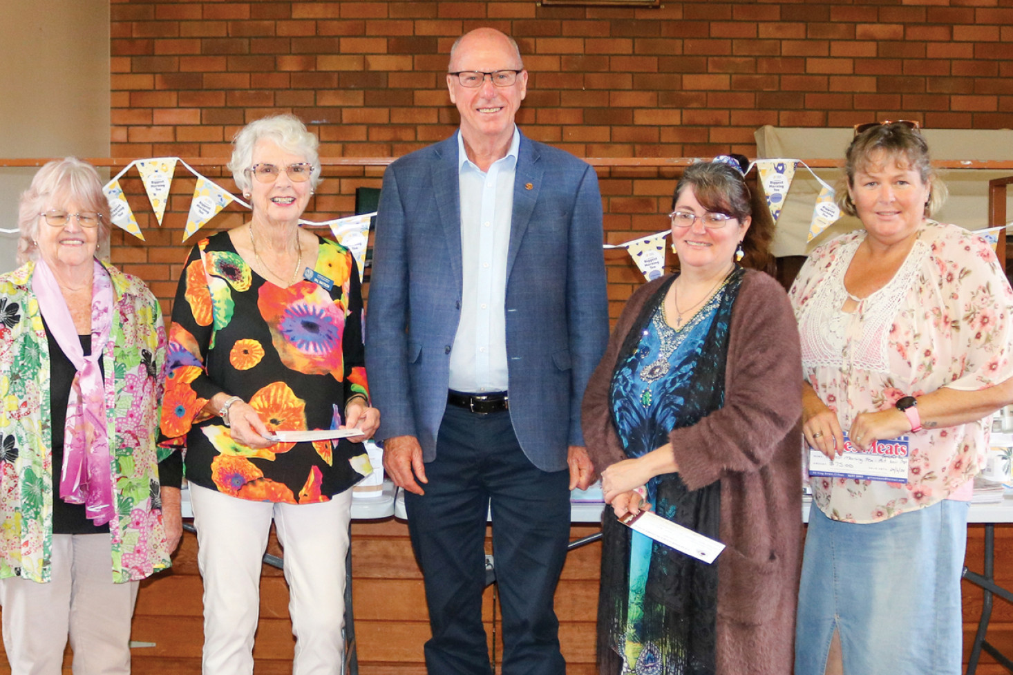 Event organiser Alice McKenzie (left) and Member for Condamine Pat Weir (centre) present the lucky door prizes to, from left, Val Watson, Jodie Ovington and Jenny Gillam.