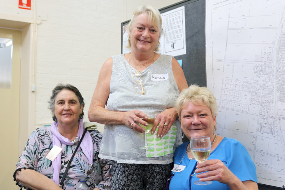 Sales agent Helen King (right) shares a toast with Pamela Marshall (left) and Patricia Riddell.