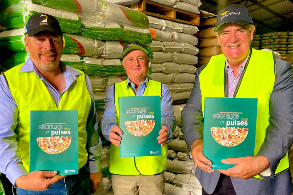 From left: AgForce’s Brendan Taylor, PB Agrifoods’ Peter Brodie and Minister Furner showing off the new guide on mastering pulse storage.