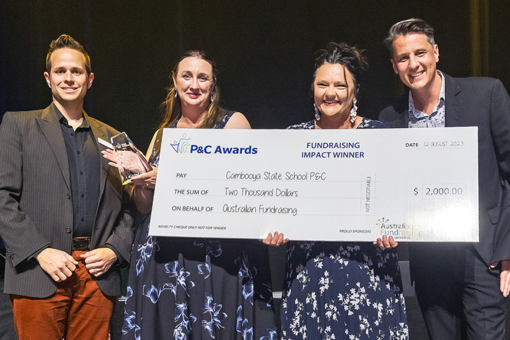 Cambooya State School P&C representatives Lisa Sternberg and Kristie Williams accepting their giant cheque from P&Cs Queensland and Australian Fundraising.