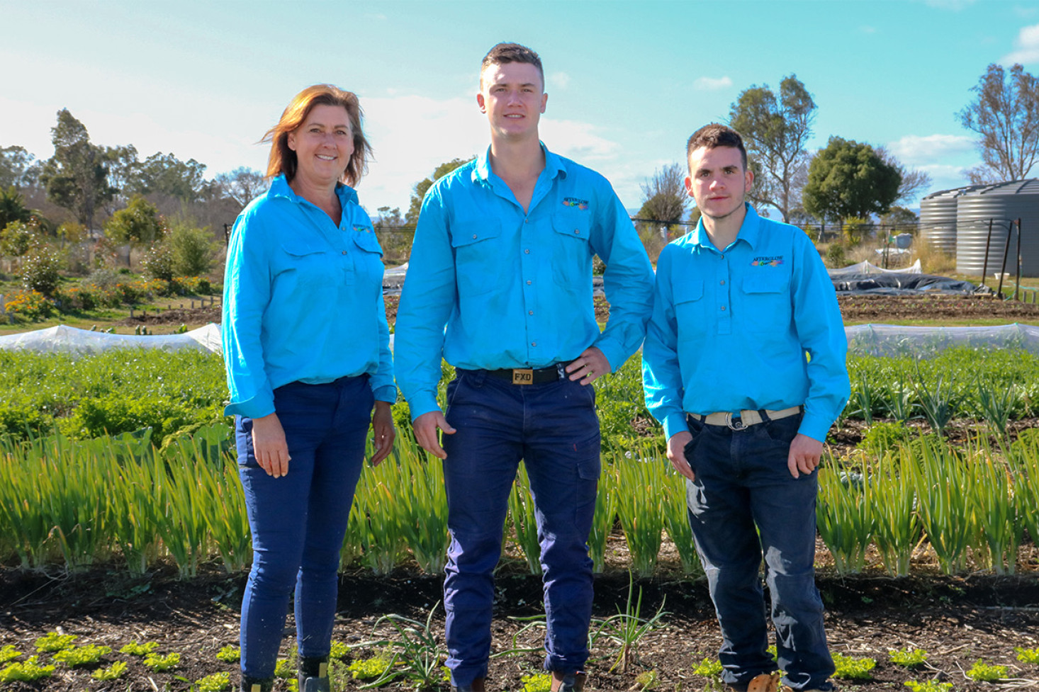 The Edwards family, from left, Fiona, Kehan and Hayden, in amongst the Afterglow Organics produce at their Cemetery Road, Clifton, property.