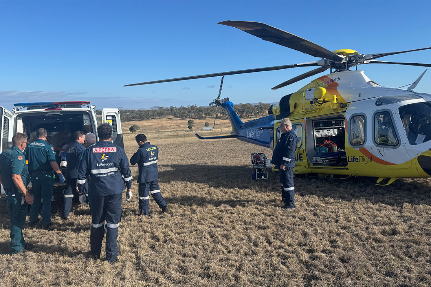 QAS and LifeFlight personnel transfer the injured woman from an ambulance to a helicopter, which took her to Brisbane. Photo, LifeFlight