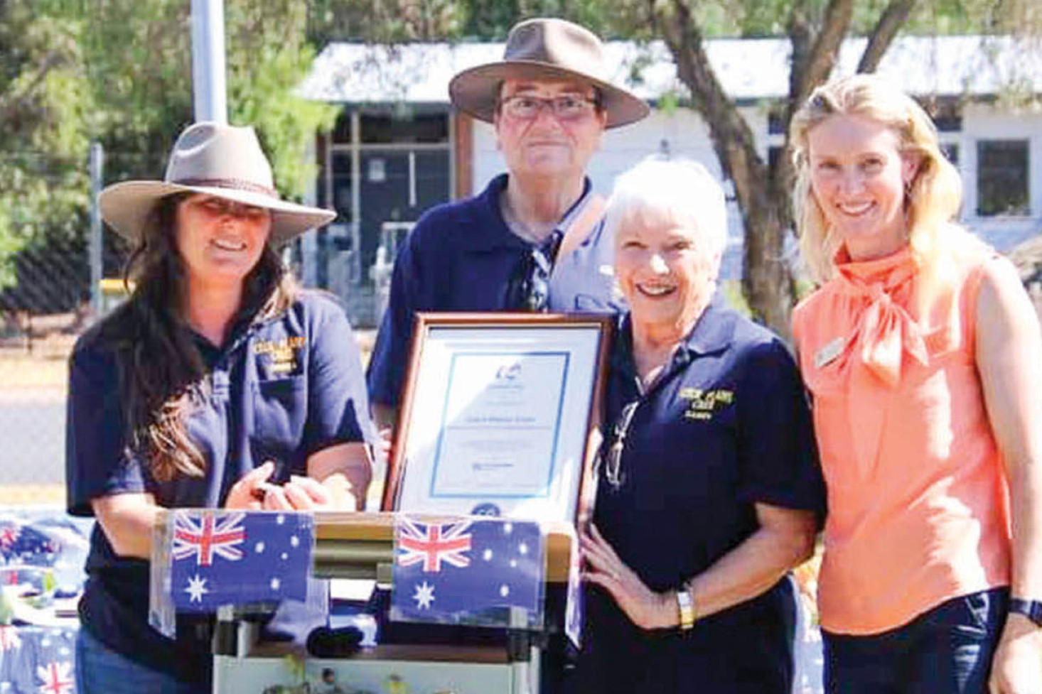 Debra Lynch (Editor), Tom Olley (President) and Sandy Kingshott (Secretary) receive an award at the Cecil Plains Australia Day Awards from Toowoomba Deputy Mayor Rebecca Vonhoff.