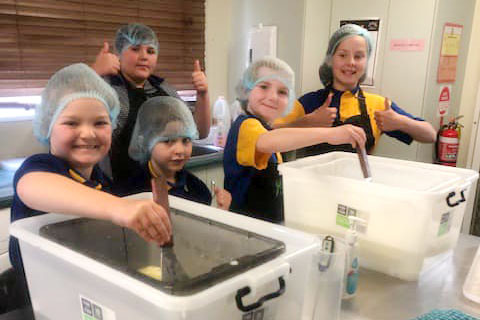 Bowenville State School students mixing up batches of blue cheese and camembert ready for the Ekka in August.