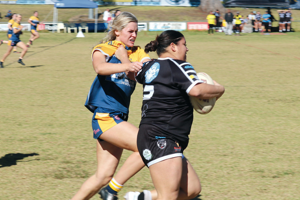 Oakey centre Clarissa Janes fends her Highfields counterpart Jess Fitzgibbon