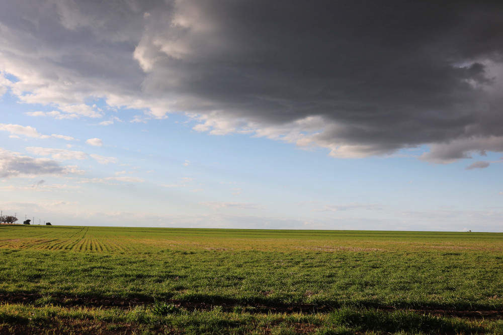 Expect a few dark clouds over spring such as this one above a farm at Spring Creek.