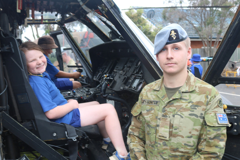 Oakey State School student Marley was shown the controls of this Army Aviation aircraft by Craftsman Alley-Sonter from Swartz Barracks.