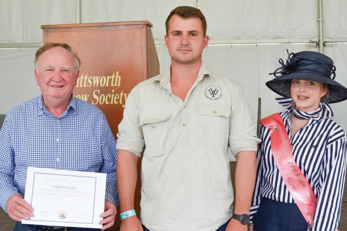 Clemens Waetjen (centre) of Yarramalong Farming, received first place in the irrigated wheat competition. Presenting his award was PB Agrifood representative Peter Brodie and 2024 Junior Showgirl Jess Hegarty.
