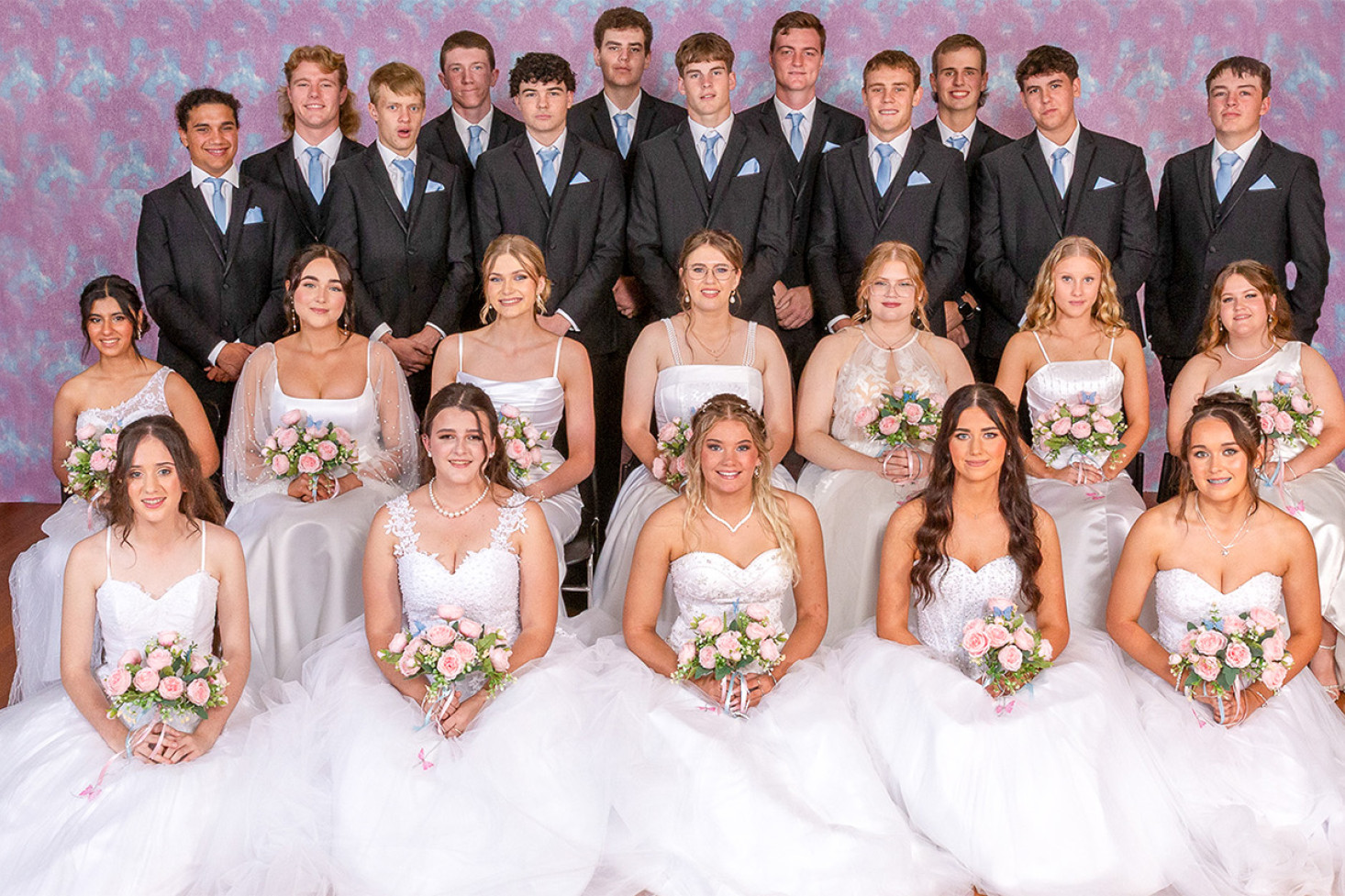The 2025 Debutantes and their partners. Back row, left-right: Ethan King, William Collins, Mitchell O’Brien, William Hanlon and Thomas Moore. Third row: Dallen Kelly, Henry Polzin, Joseph Hamlet, Ben Bourke, Tyson Moore, Jak Koza and Brock Carter. Second row: Freya Santsingh, Sienna Anderson, Alecia Lowe, Erika Ferdinand, Olivia Sutton, Emma Scobie and Ella Lewis. Front row: Keira Quinn, Chloe McEwan, Sophie Heinemann, Indyara McMurray and Tatum Scurr. Photo, Tamara Silvester of Butterfly Kisses Creations