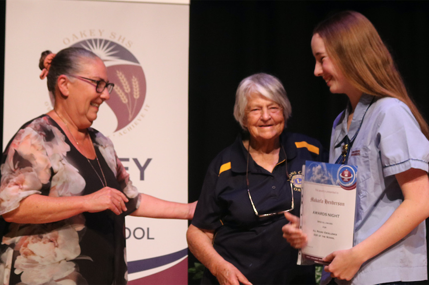 Head of Senior Schooling Jodie Beauchamp and Lois Thorne, representing sponsor Oakey Lions Club, congratulate OSHS Senior Dux Makaela Henderson.