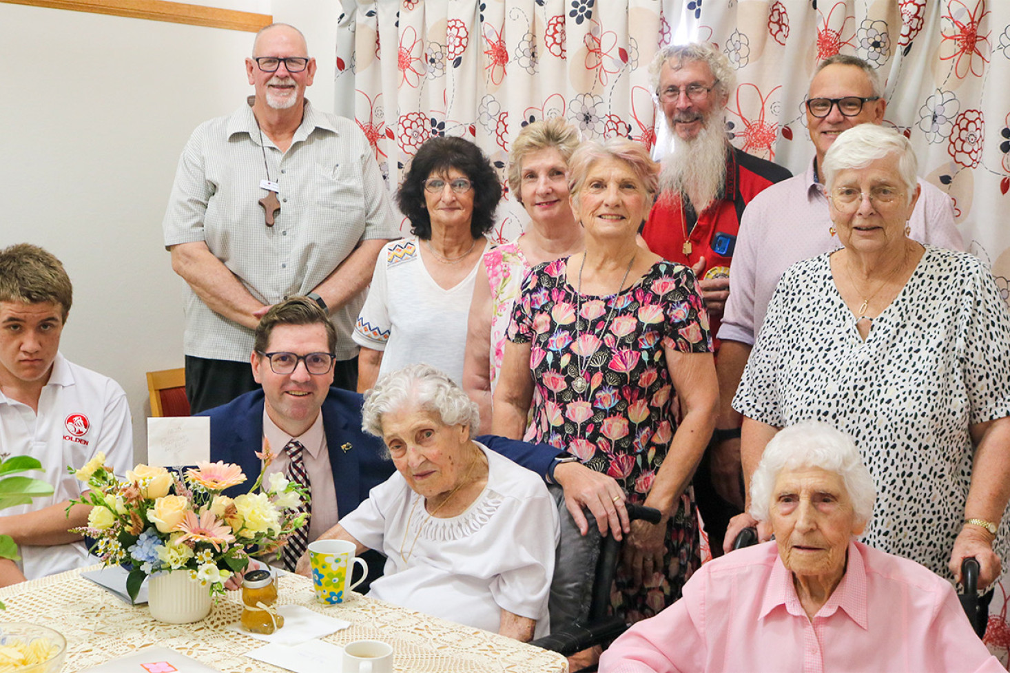 Celebrating Edna Bryce’s 107th birthday were (standing from left) Ps. Charlie Uebergang (Beauaraba Living Pastoral Carer), Lynette Brown, Narelle Briskey, Kathy Hohn, Gary Seagrott, Rev. Willie Liebenberg (Uniting Church Minister), Di Oehlman, (sitting from left) Geoff McDonald, Edna Bryce and her sister Irene (Rene) Seagrott.