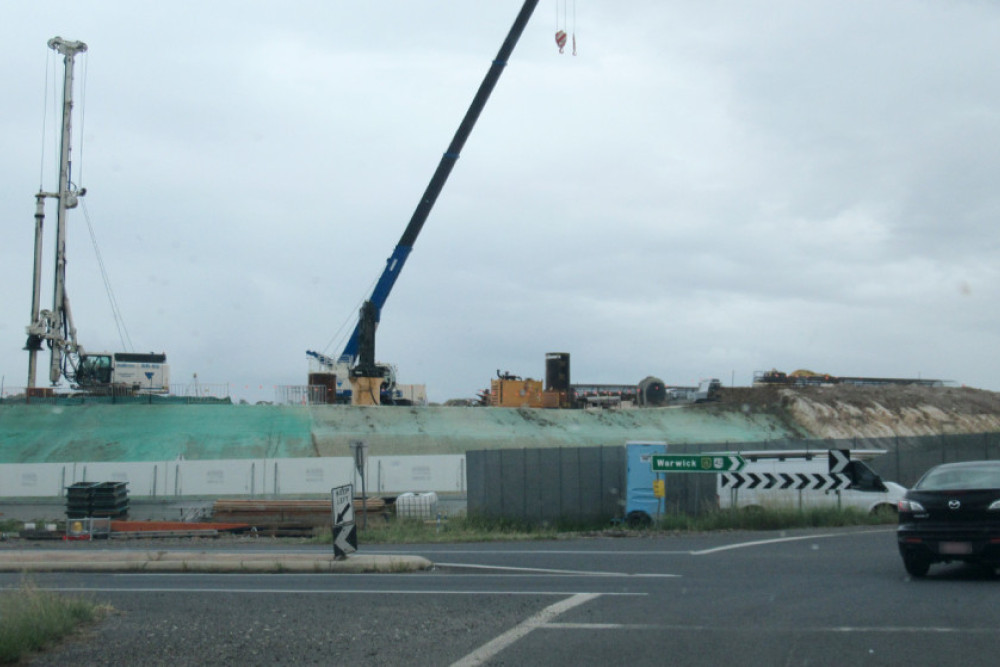 The new overpass for southbound traffic on the New England Highway is starting to rise above the Cunningham Highway junction.