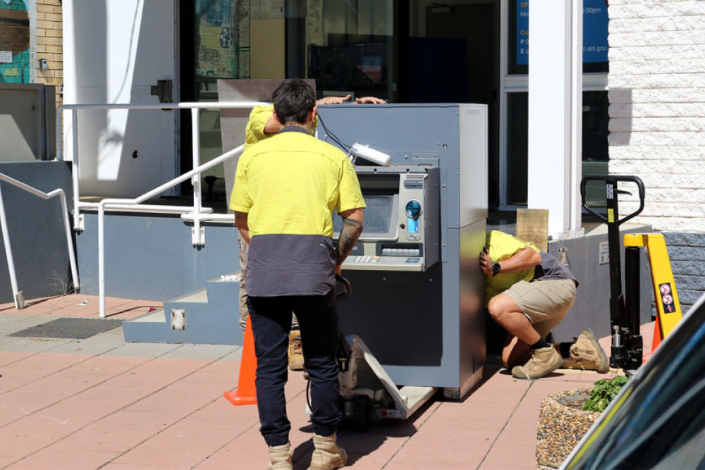 A crew removing the ANZ ATM from the front of the former bank building on Campbell Street.