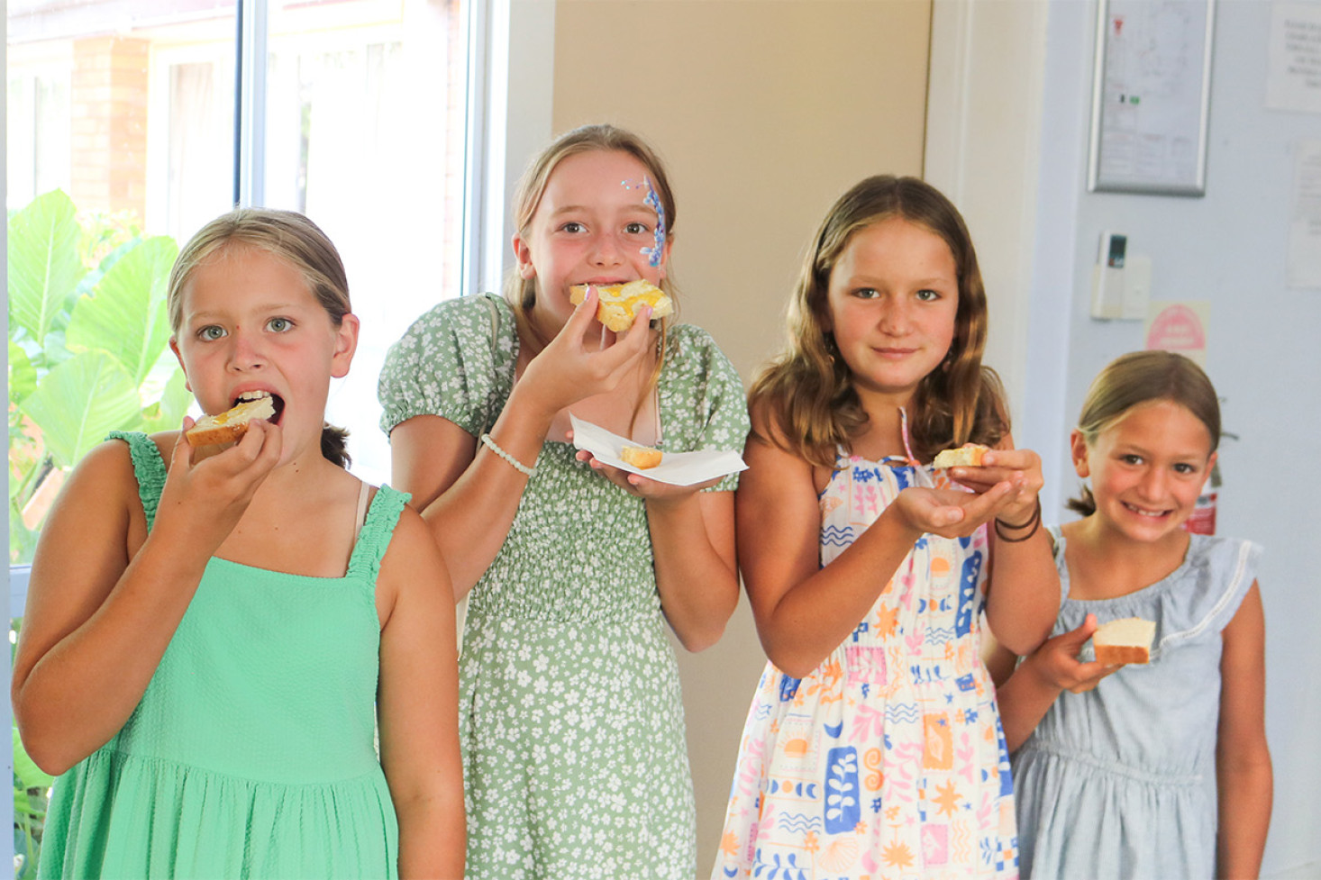 Enjoying the homemade damper provided by Janene Howard and Lyn Pearce after the ceremony were Abi, Verity, Matilda and Esther.