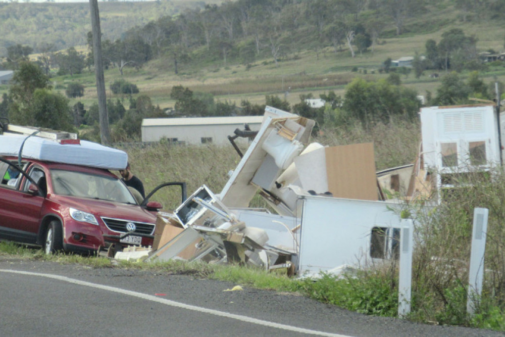 Debris alongside the New England Highway at Eton Vale following Saturday’s crash.
