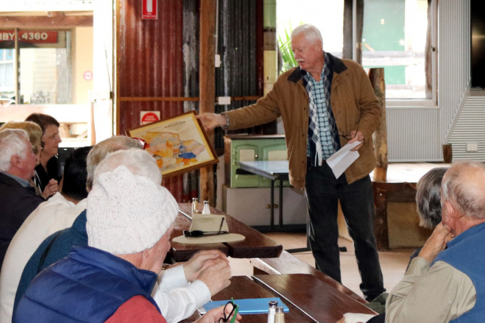 Ian Whan sharing some details of the book and a map of the area with those who attended.