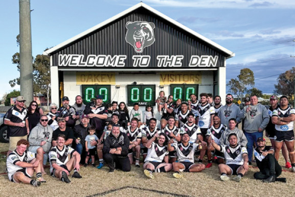 The Oakey Bears unite around the Dolan family in front of the scoreboard. Photo: Zoe Boyd.