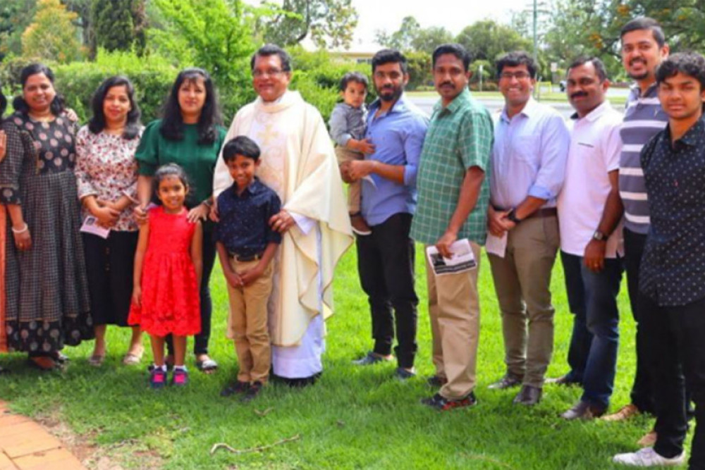 Father Thomas with his family and friends.