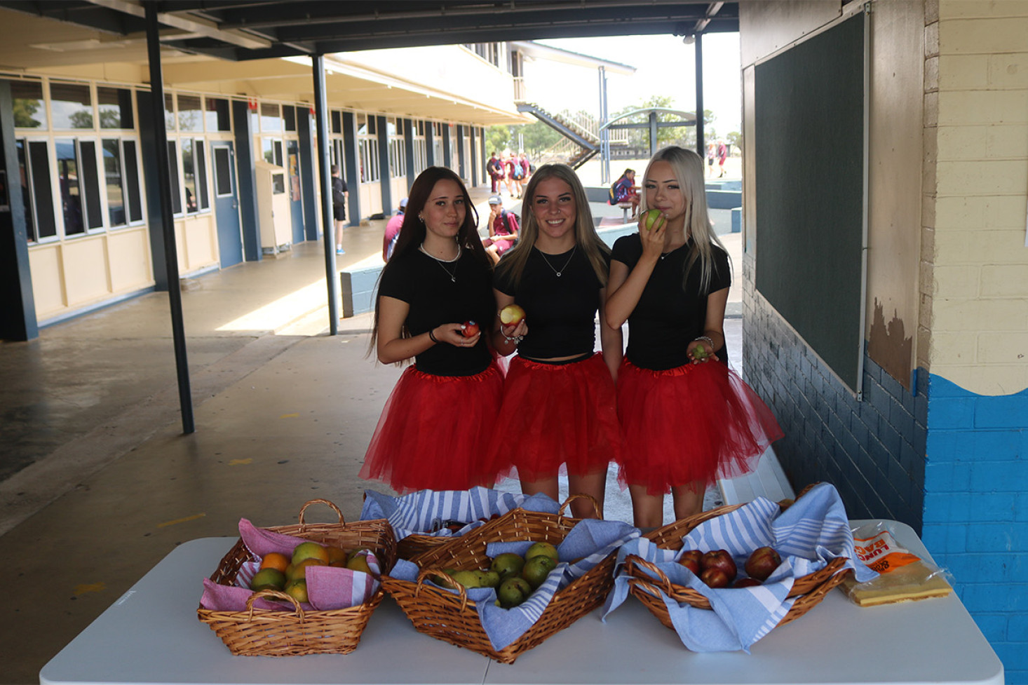 Students Jenna, Peta and Willow try out some of the produce on offer.