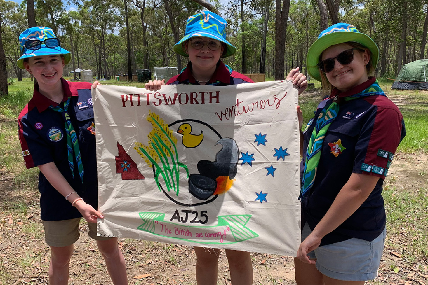 Pittsworth Venturers Ava Schultz, Chloe Burrows and Jesa Allen with their gateway banner.