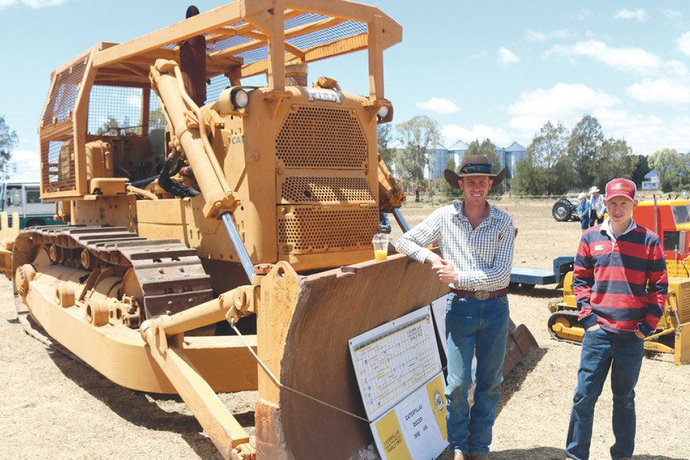 ABOVE: Visitors Ian Pincott from Maidenwell and Jimmy Klein from Pittsworth stand next to a Caterpillar Dozer.
