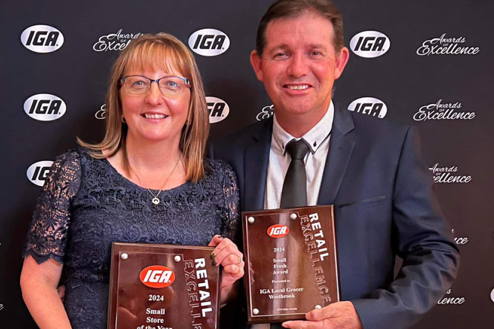 The Local Grocer IGA Westbrook owners Tracey and Shane Smith with the two awards their store won.