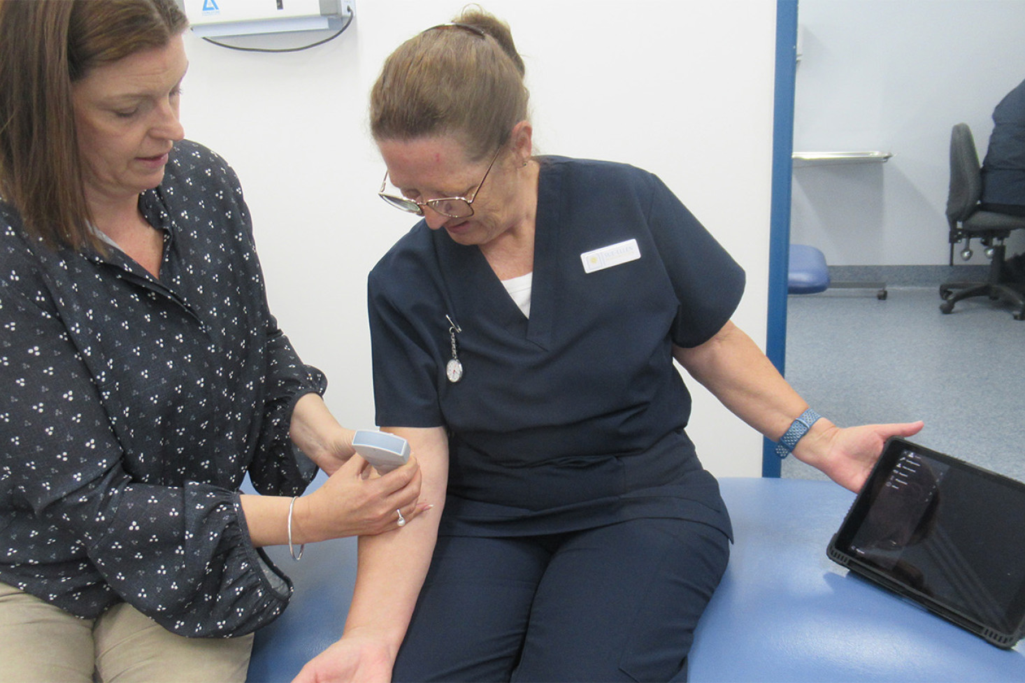 Ultrasound machine being demonstrated by Dr Claire Schmidt on Nurse Sue-Ellen.