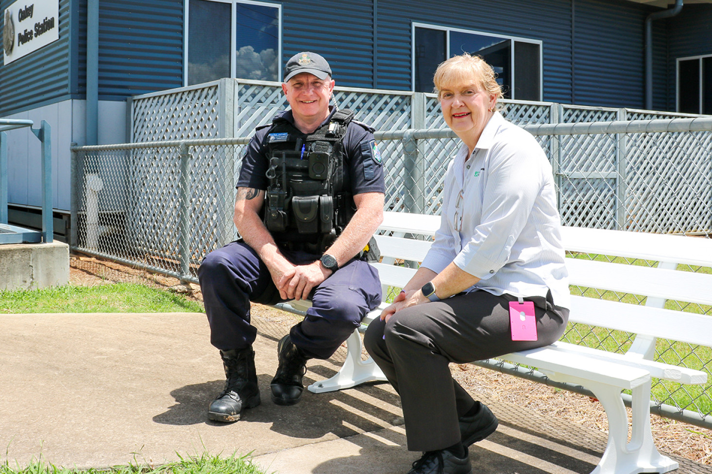 Officer-in-Charge of Oakey Police, Acting Sergeant James Leahy with Toowoomba Regional Council’s Community Development Officer - West, Karen Suhl on the new community seat at the front of the Police Station.