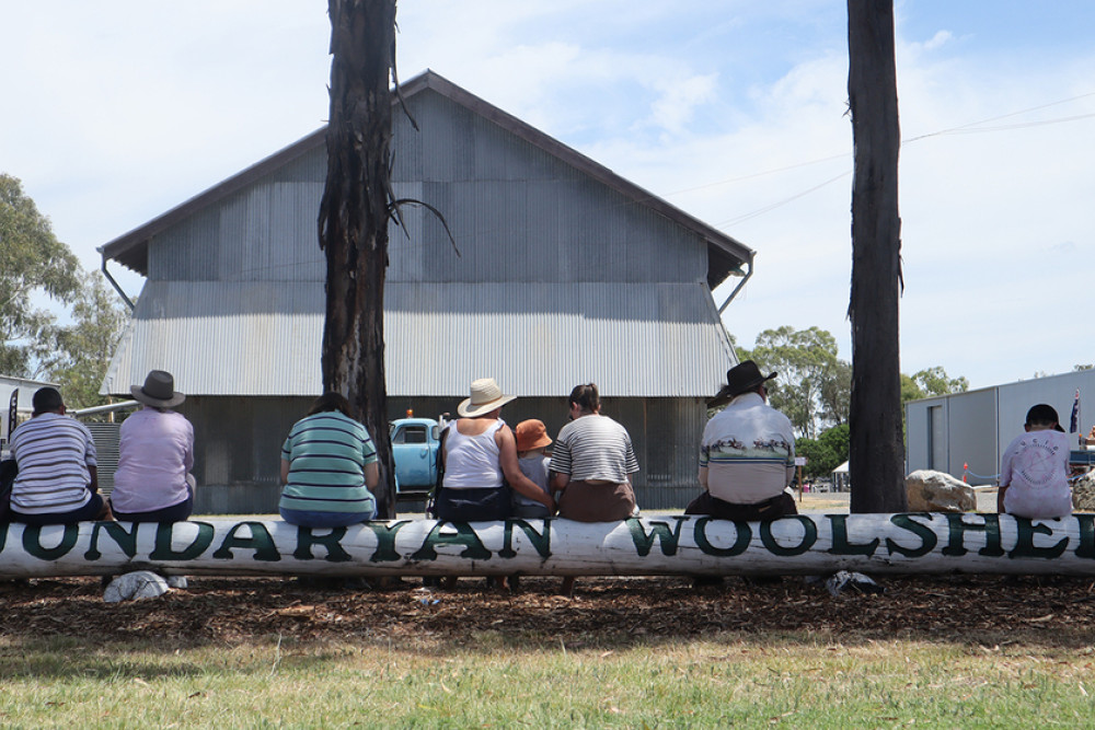 ABOVE: On a hot day, patrons rest on the Jondaryan Woolshed sign.