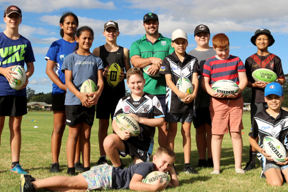 NRL regional development officer, Mal Sweeney (centre, back row) with some of the Oakey Junior Bears players at the sign-on event last week including new club ambassador Leteena Medland. Mr Sweeney led the young people in a set of rugby league drills and exercises.