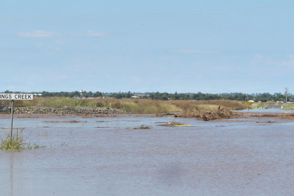 The bridges over Kings Creek and Neds Gully on Felton Clifton Road are fully submerged in water, the depth marker showing the water is at a height of 1 metre at 11am today.