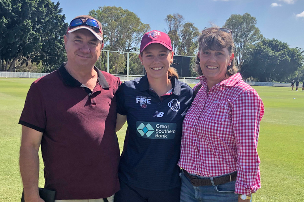 Kira with parents Glen and Christine Holmes.