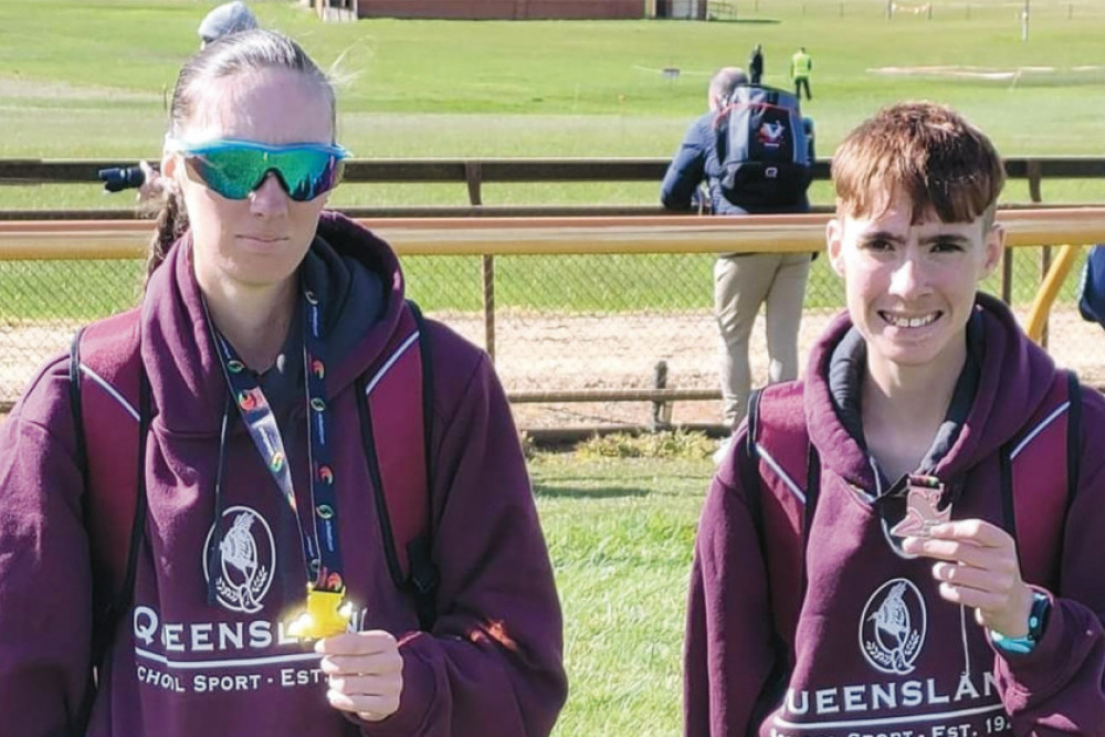 Kyrna and Tomas Crump proudly displaying their medals.