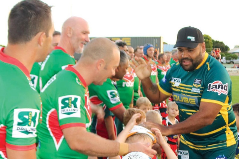 NRL footy legend Sam Thaiday shakes hands with the Rebel Sport Pittsworth Danes All Stars, and high fives the junior fans, prior to the big game on Saturday night.