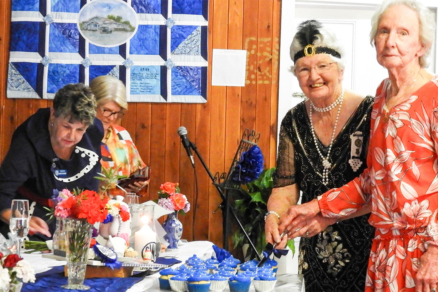 Mary Hamblin and Alexis McCarthy cut the cake.