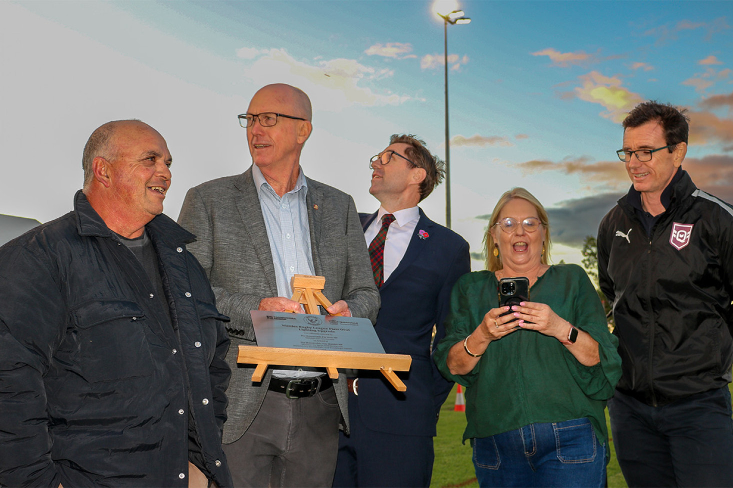 The official party was pleased to see success as the new lighting system was activated by a mobile phone signal. From Left: First Nations Elder Charlie Waters who gave the Welcome to Country, Member for Condamine and Speaker of the Queensland Parliament Pat Weir, Mayor of the Toowoomba Region Geoff McDonald, President of Wattles Warriors Rugby League Club Amanda O’Halloran, and Chief Executive Officer of Queensland Rugby League (QRL) Ben Ikin.