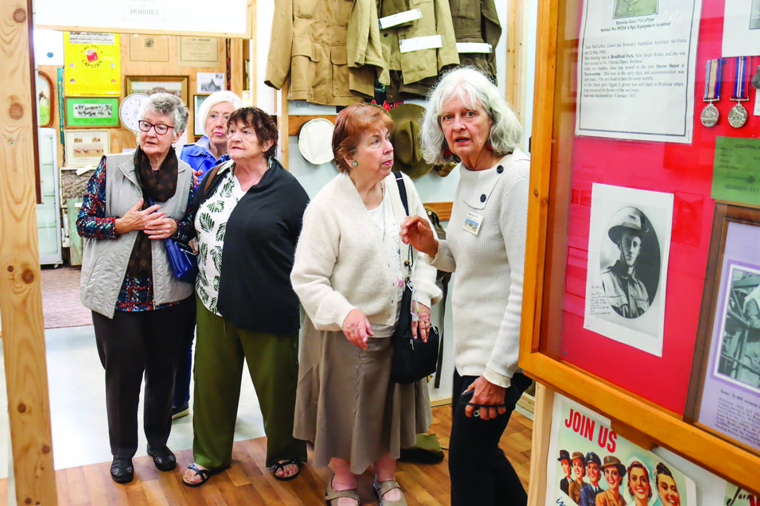 Linda Nicholas guides a clearly fascinated group from St. Thomas More’s Church around the museum’s displays.