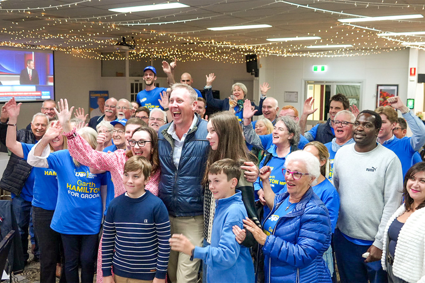 Garth Hamilton, with family and supporters, celebrates the win in Toowoomba on election night, although it was a much more joyless night for his party nationally.